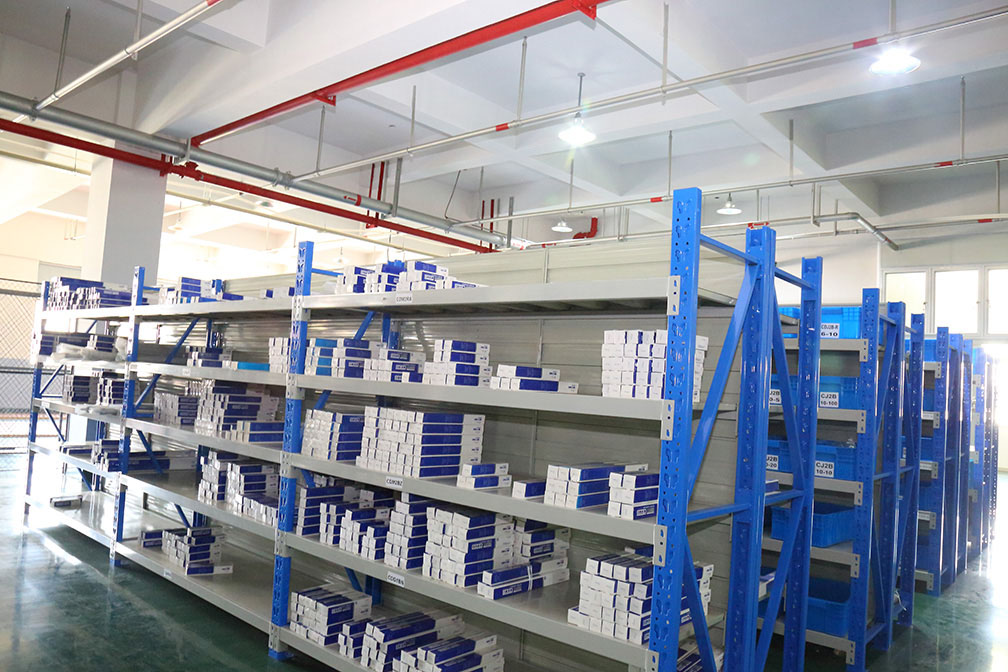 Bepto Pneumatic warehouse shelves with boxed pneumatic components ready for routing